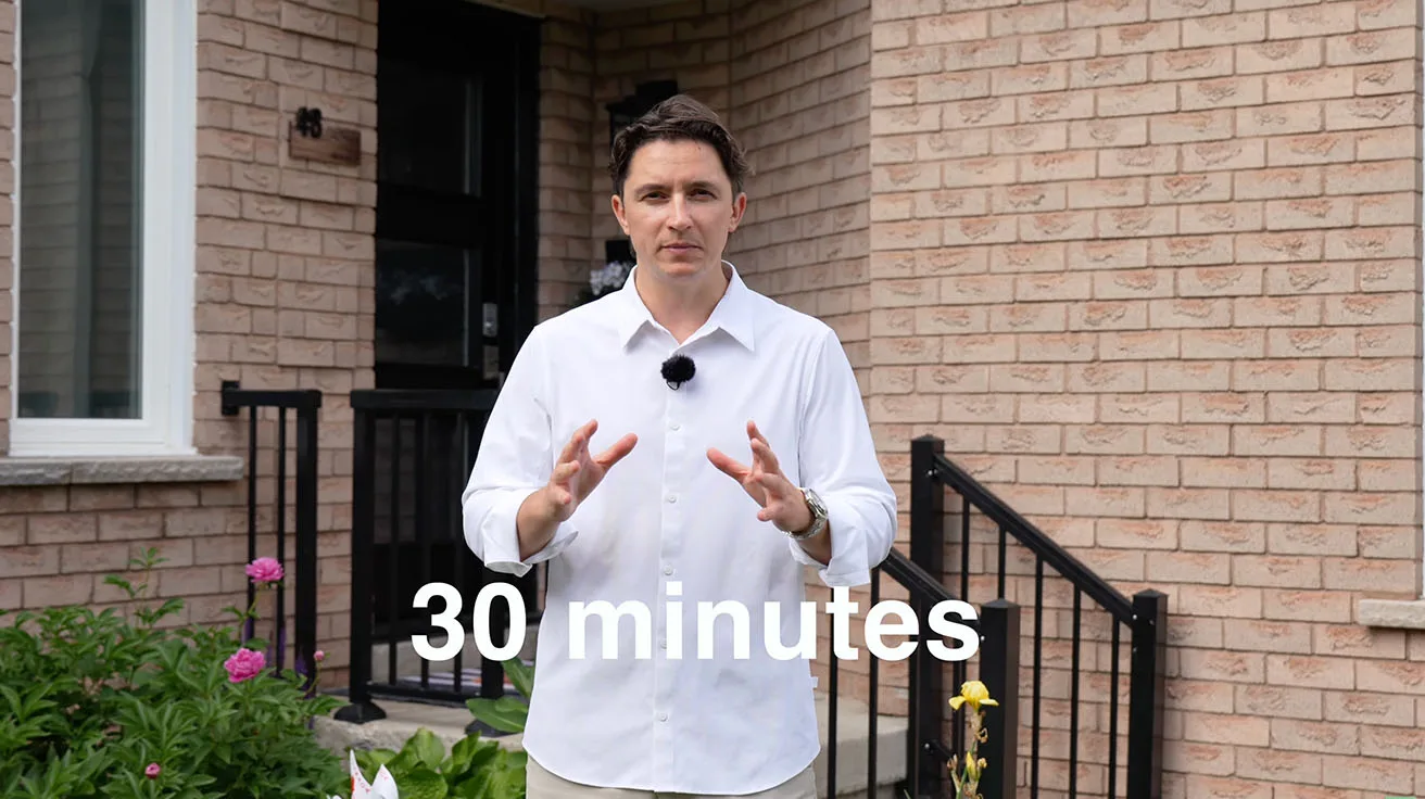 Presenter standing outside a brick home during a 30 minute solar security camera installation test