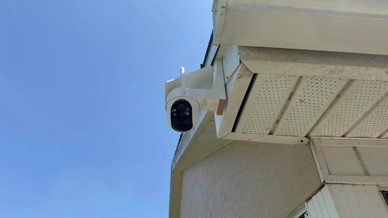 Solar security camera installed beneath a roofline in clear direct sunlight